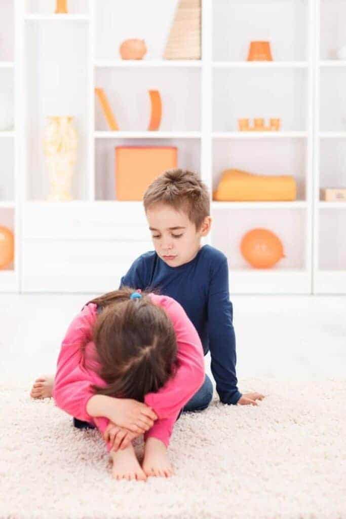  A boy and a girl fighting over toys and not getting along.