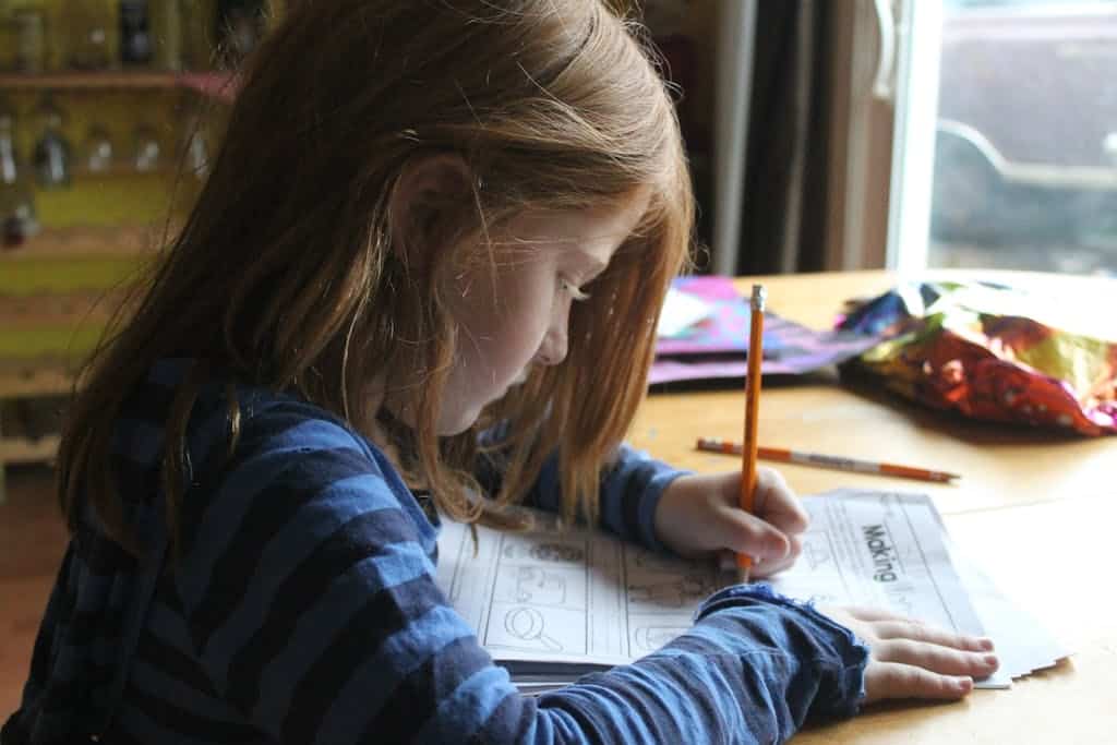 Girl Drawing On Brown Wooden Table